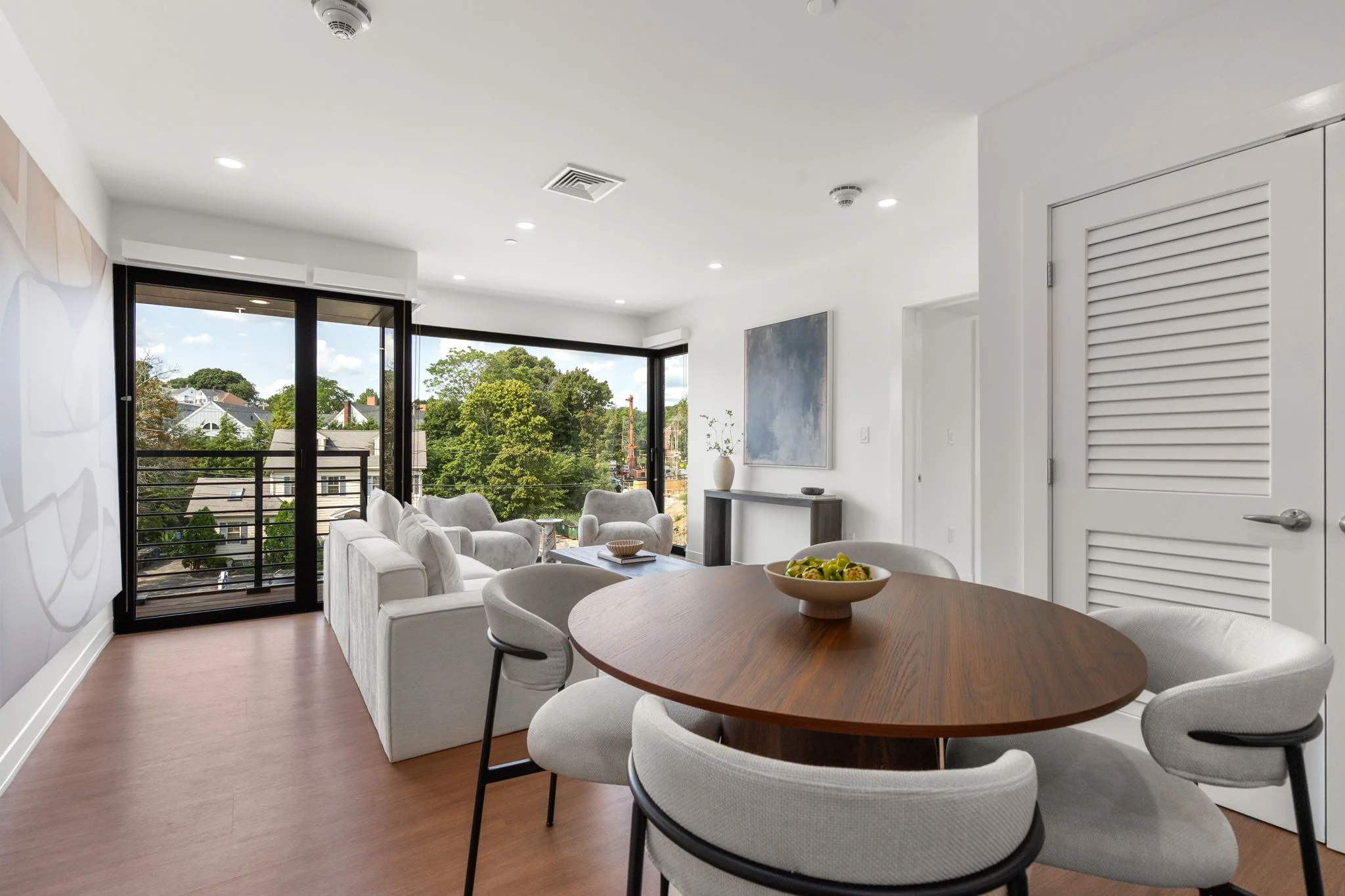 Dining table with the living room and balcony beyond