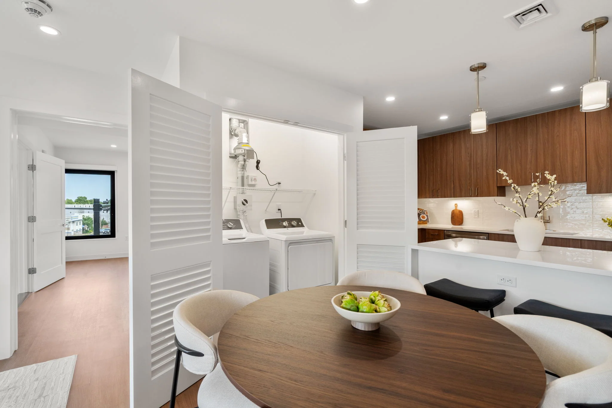 Kitchen and dining area with the laundry closet open
