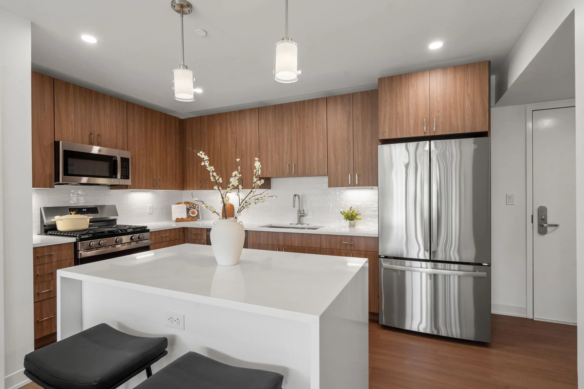 Kitchen island with wood cabinetry and stainless steel appliances