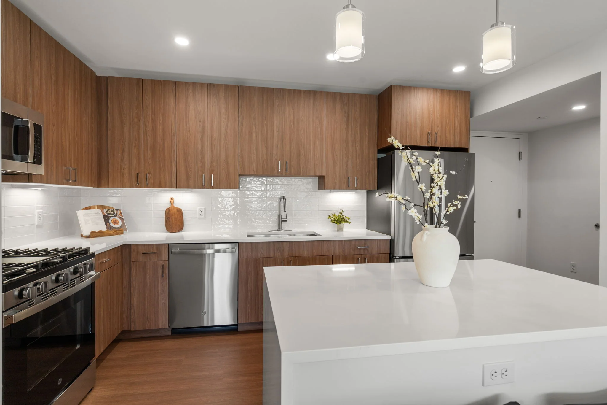 White kitchen island with the sink and dishwasher behind it