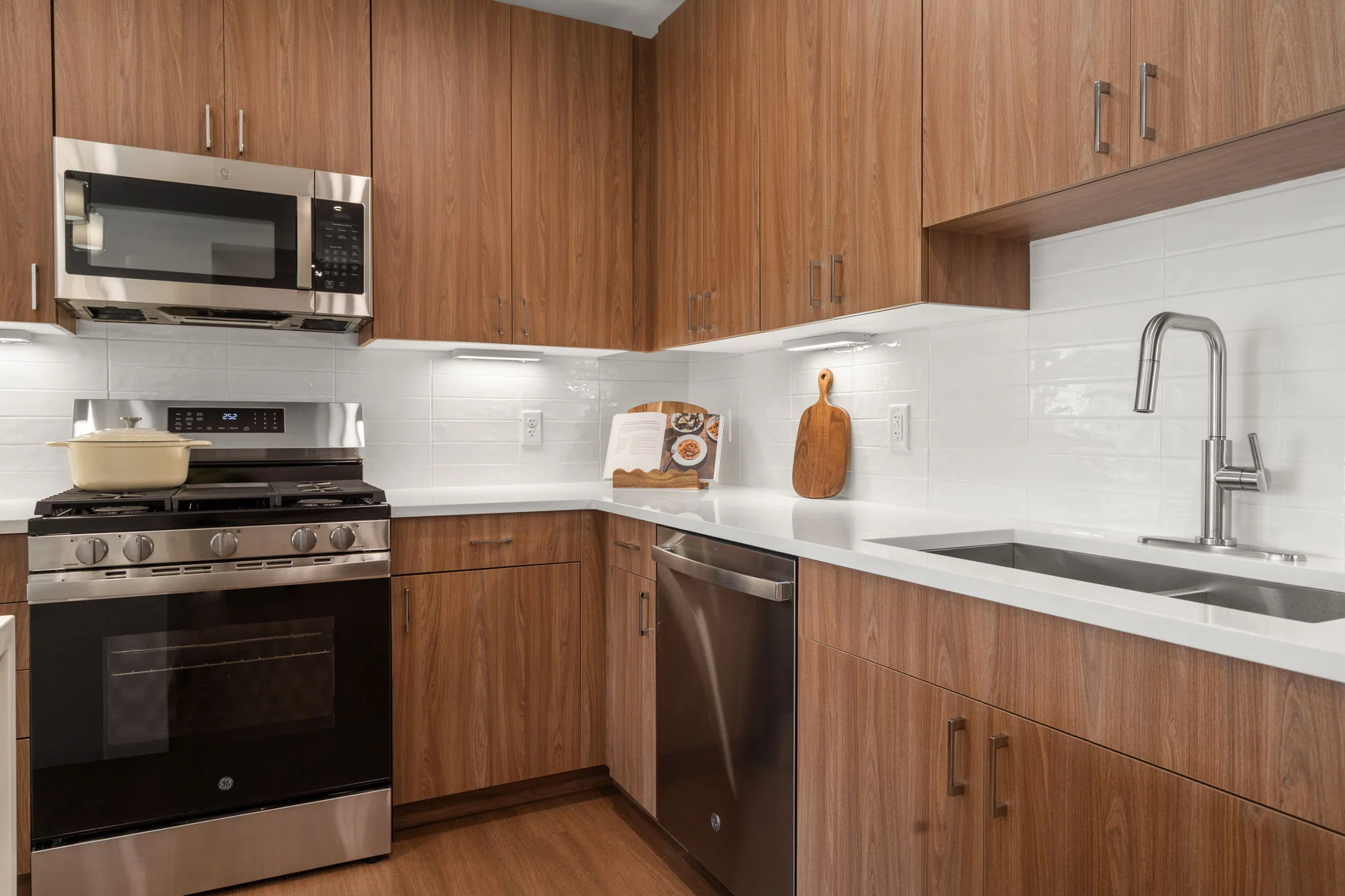 Kitchen detail showing the gas range, microwave, and sink