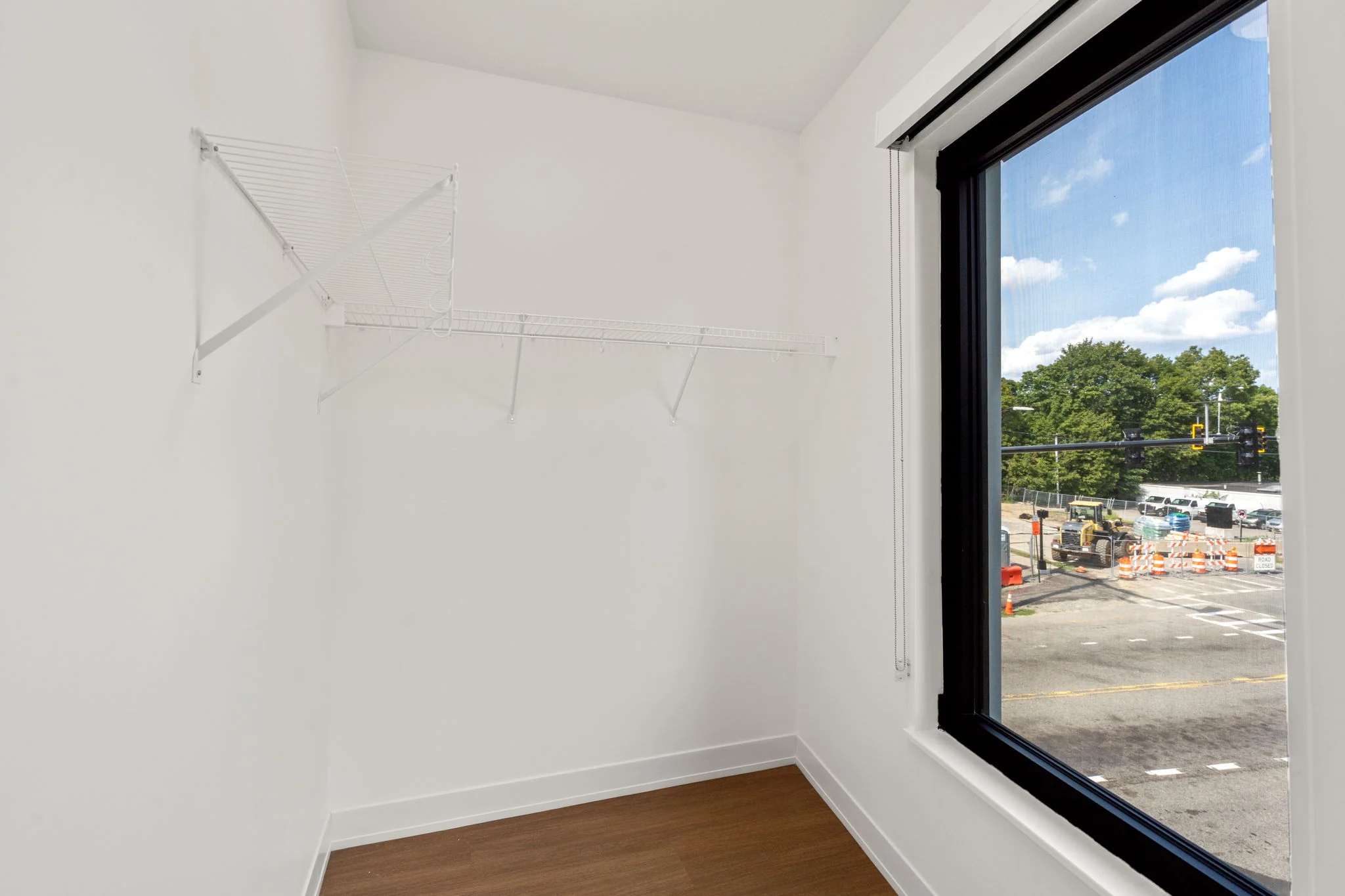 Walk-in closet with shelving and a large window